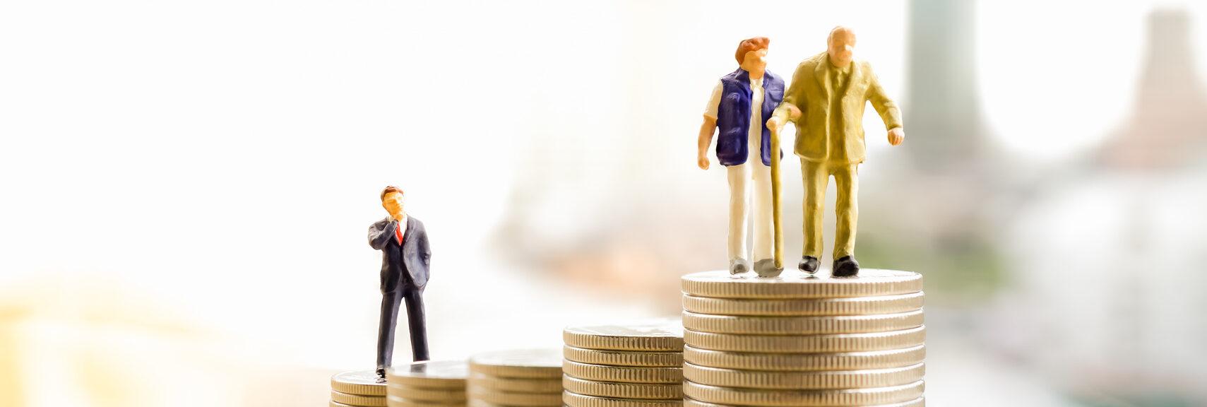 Concept of retirement planning. Miniature people: Old couple figure standing on top of coin stack.