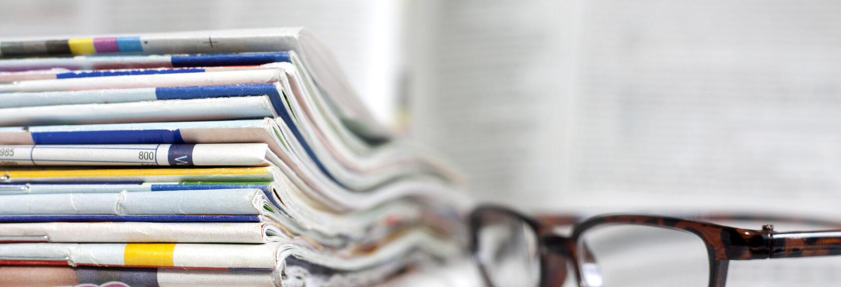 Newspapers and magazines blurred background concept