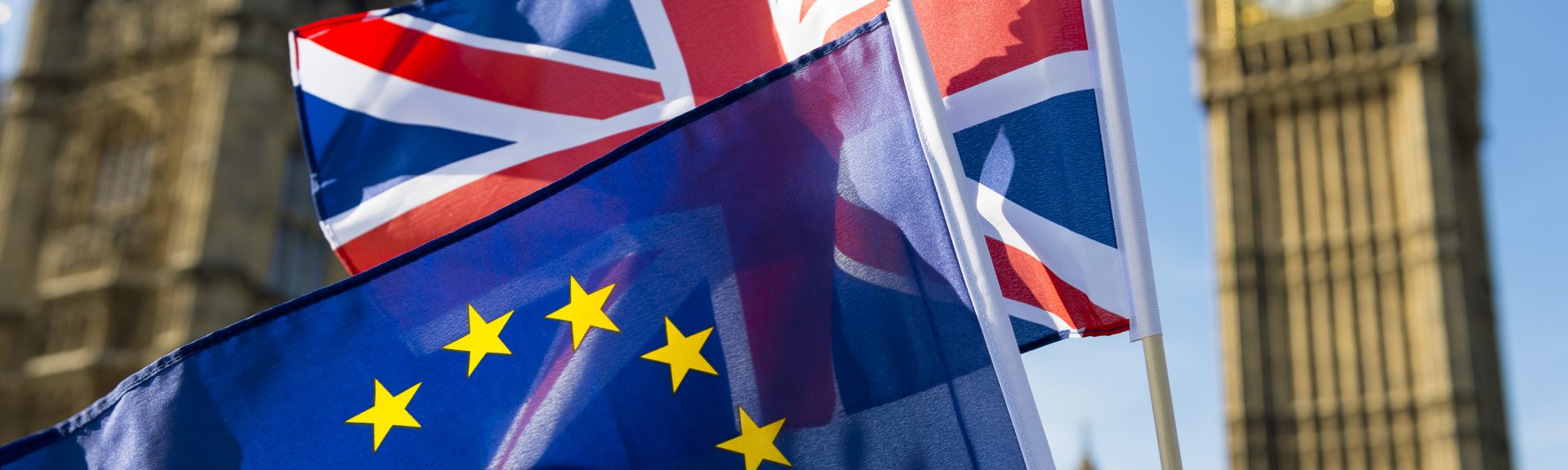European Union and British Union Jack flag flying in front of Big Ben and the Houses of Parliament at Westminster Palace, London, in symbol of the Brexit EU referendum