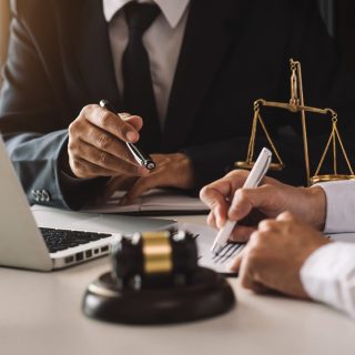 business people and lawyers discussing contract papers sitting at the table. Concepts of law, advice, legal services. in morning light