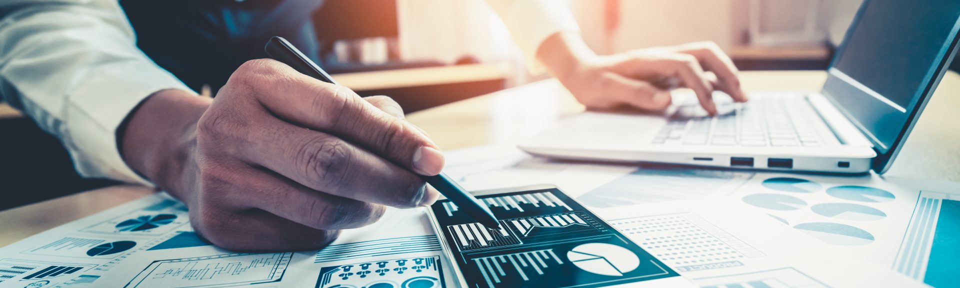 Businessman accountant or financial expert analyze business report graph and finance chart at corporate office. Concept of finance economy, banking business and stock market research.