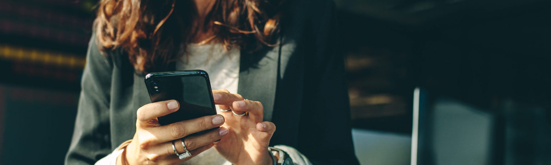 Cropped shot of a businesswoman with a on mobile phone in office. Business executive using a phone in office.