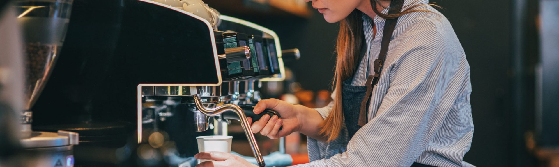 Female barista making coffee.