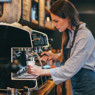 Female barista making coffee.