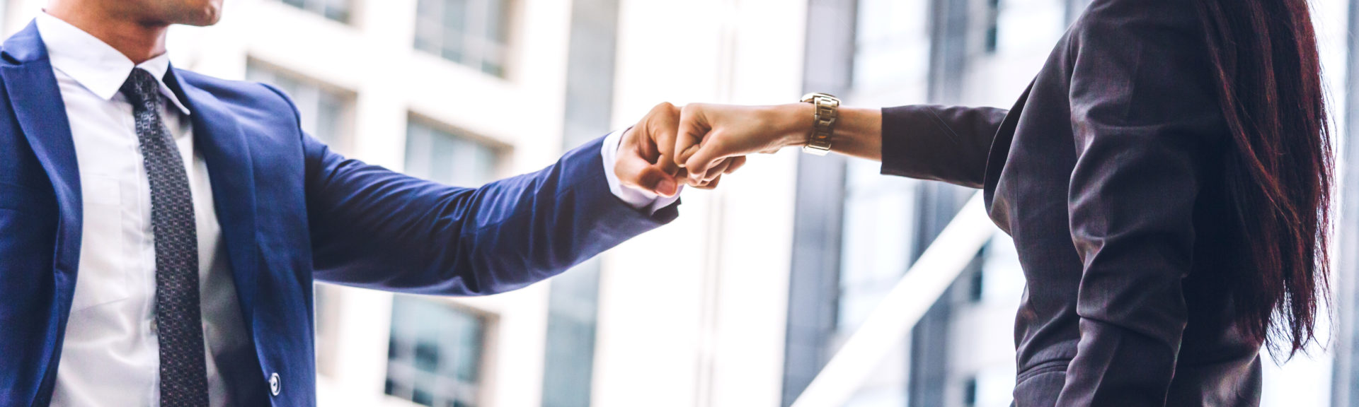 Businessman and partner giving fist bump hand