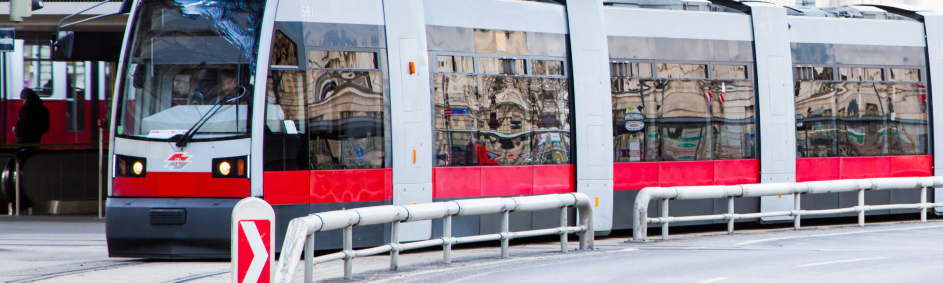 Modern red tram making turn at ringstrasse street at the center of Vienna, Austria