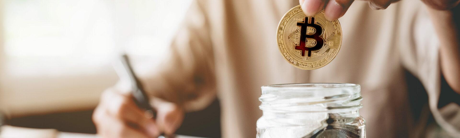 Businessman putting bitcoin into piggy bank and using calculator to analysis business investment with many document graph data, CryptoCurrency Financial Concept.