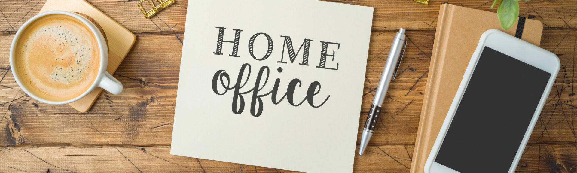 Home office and working from home concept. Table workplace with keyboard computer, notepad and coffee cup. Top view from above