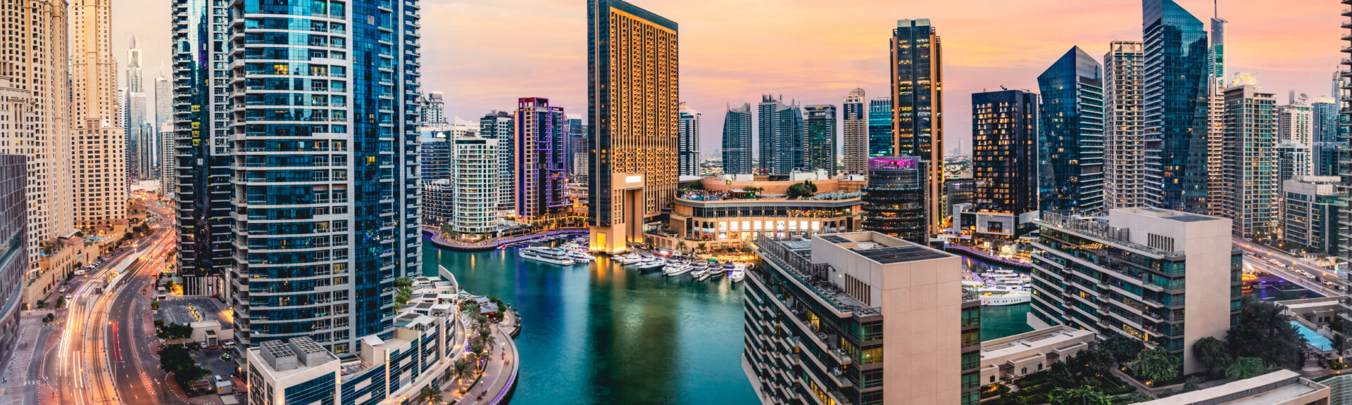 Dubai marina skyline in UAE at sunset. High-rise residential buildings, business skyscrapers