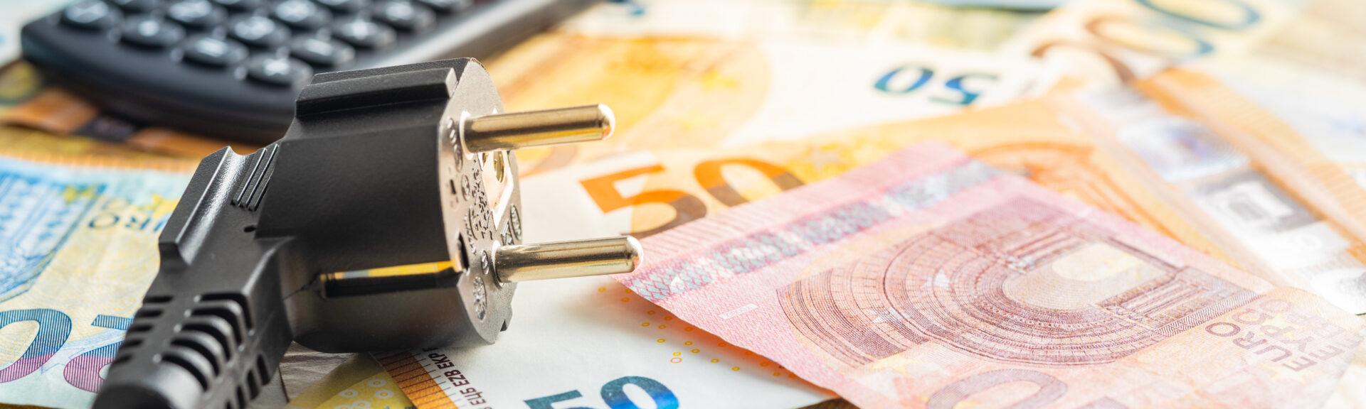 Electric plug, calculator and euro money. Concept of increasing electricity prices.