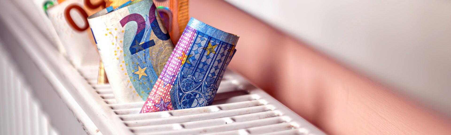 euro banknotes in a central heating radiator, the concept of expensive heating costs, close-up