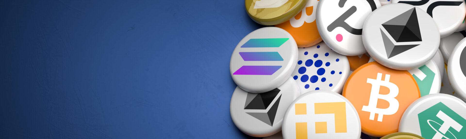 Logos of the main cryptocurrencies Bitcoin, Ethereum, Binance, Cardano, Ripple, Dogecoin, Tether, Solana, Polkadot on a heap on a table. Copy space. Web banner format