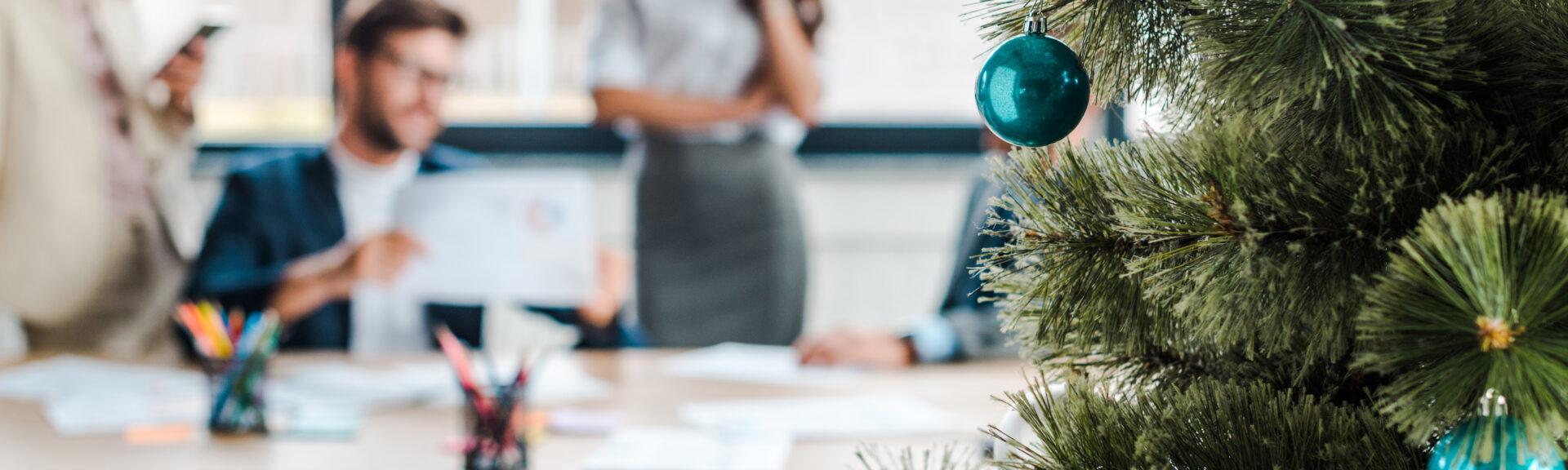 selective focus of decorated christmas tree near multicultural c