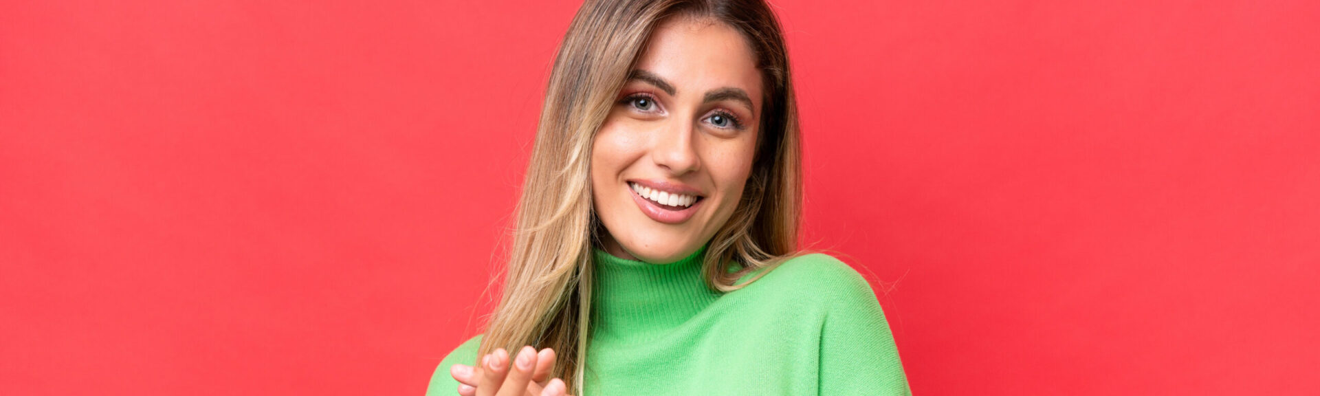 Young Uruguayan woman isolated on red background laughing
