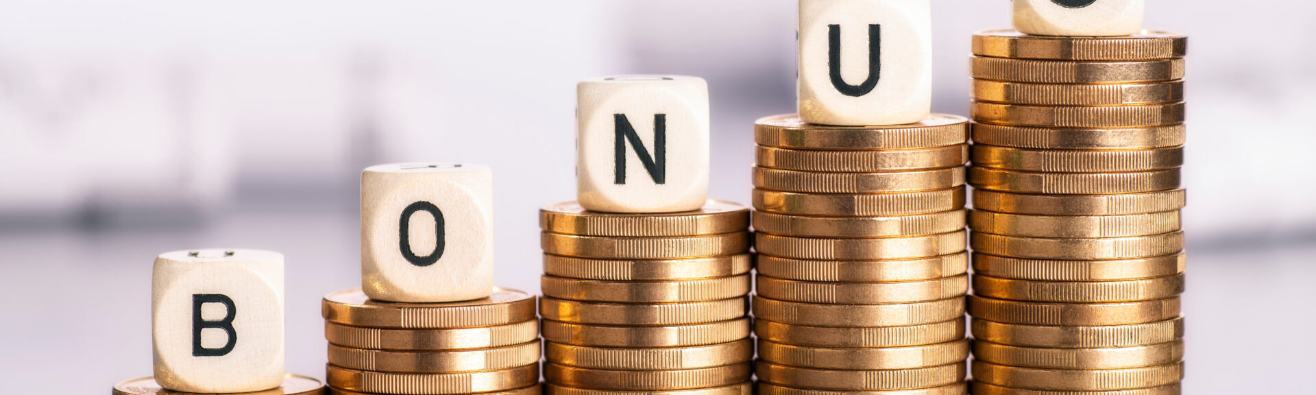 Rising stacks of coins with the word bonus