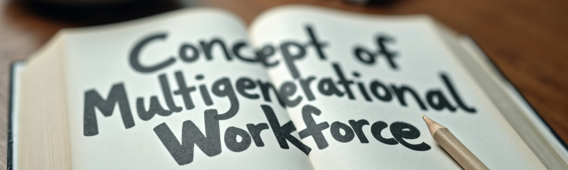Multigenerational Workforce Concept: Book on Wooden Table for HR Training, Diversity Workshops, and Business Seminars