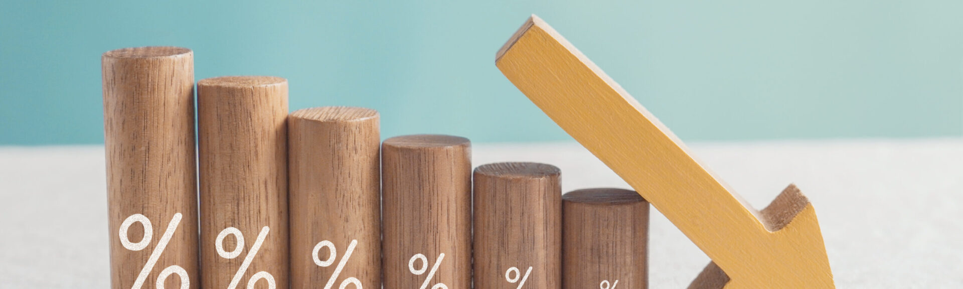 Wooden blocks with percentage sign and down arrow, financial recession crisis, interest rate decline, risk management concept