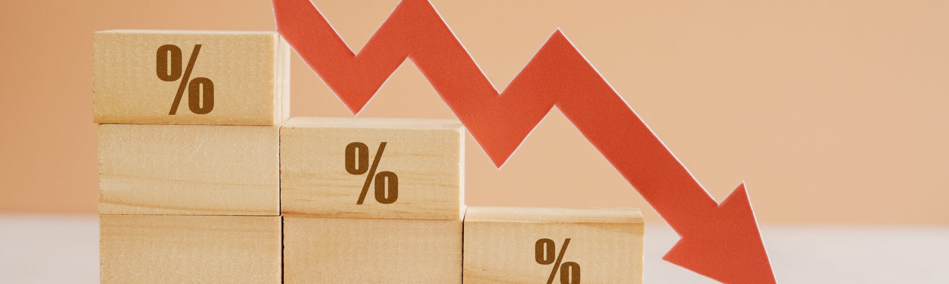 Wooden blocks with percentage sign and down arrow, financial recession crisis, interest rate fall, economic depression concept