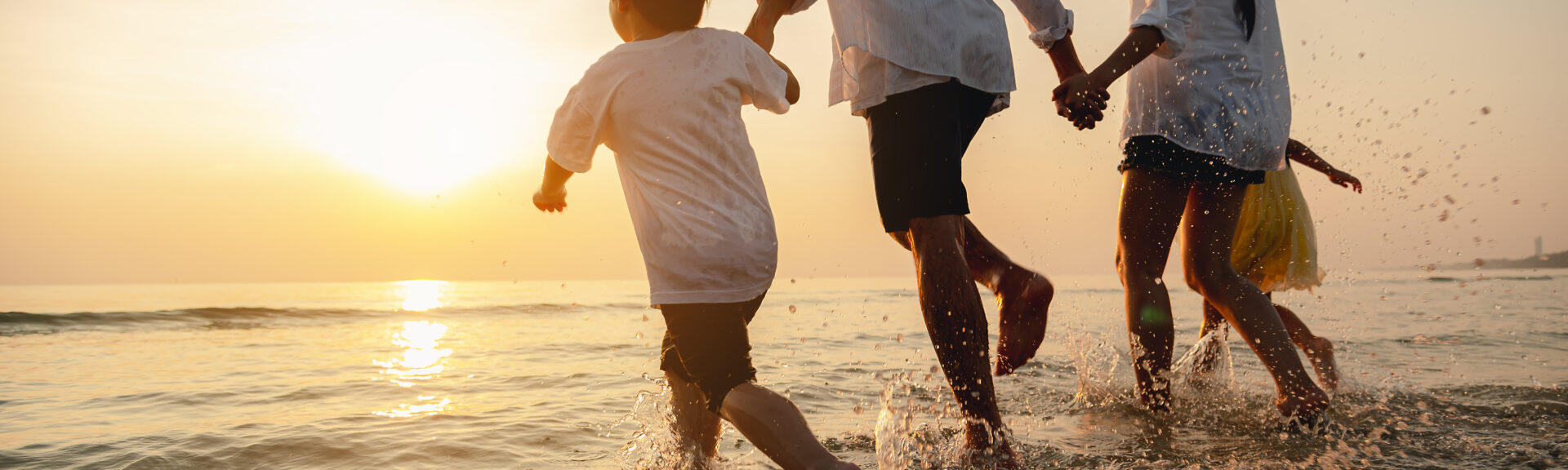 Happy asian family at consisting father, mother,son and daughter having fun playing beach in summer vacation on the beach.Happy family and vacations concept.